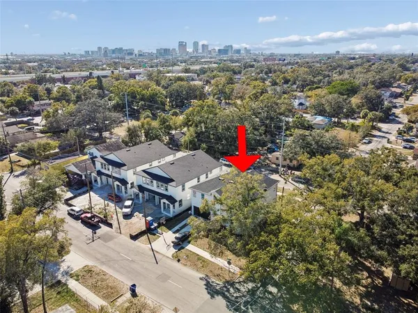 an aerial view of a houses with a city street view