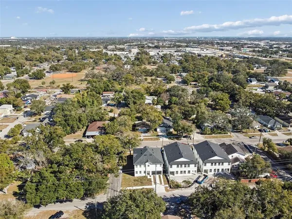 an aerial view of residential houses with city view