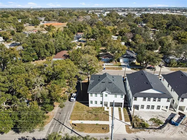 an aerial view of residential houses with outdoor space