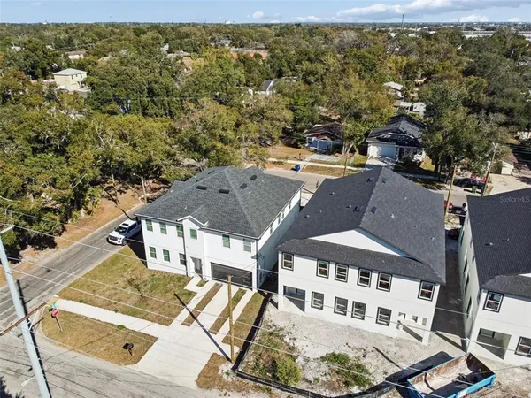 an aerial view of a house with a yard