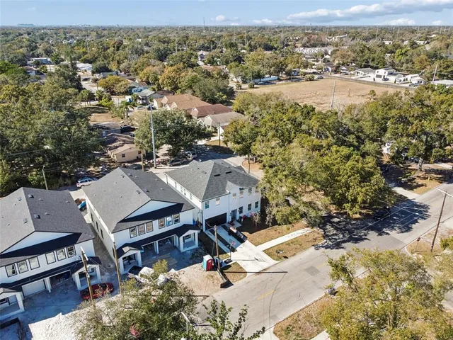 an aerial view of a house with a yard