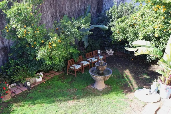 a view of a backyard with sitting area and a garden