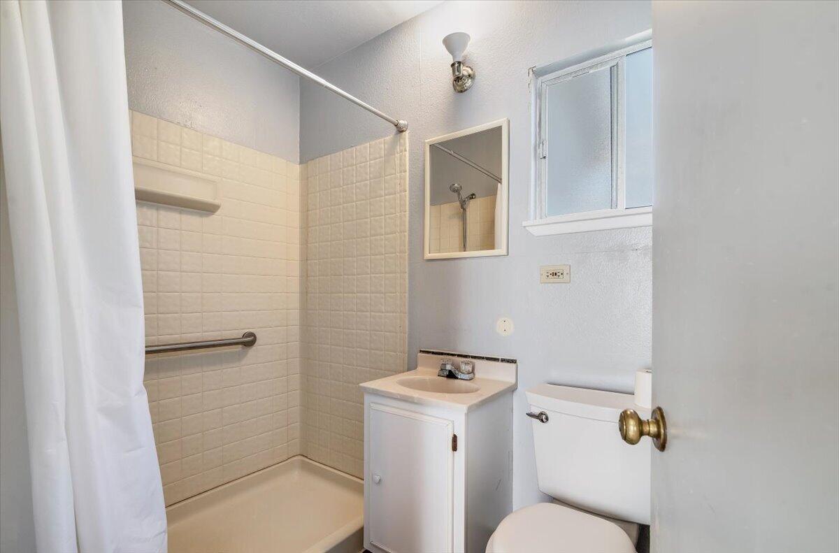 230 North D Street Lompoc, CA 93436 - Photo 13 of 29 a bathroom with a toilet and a shower