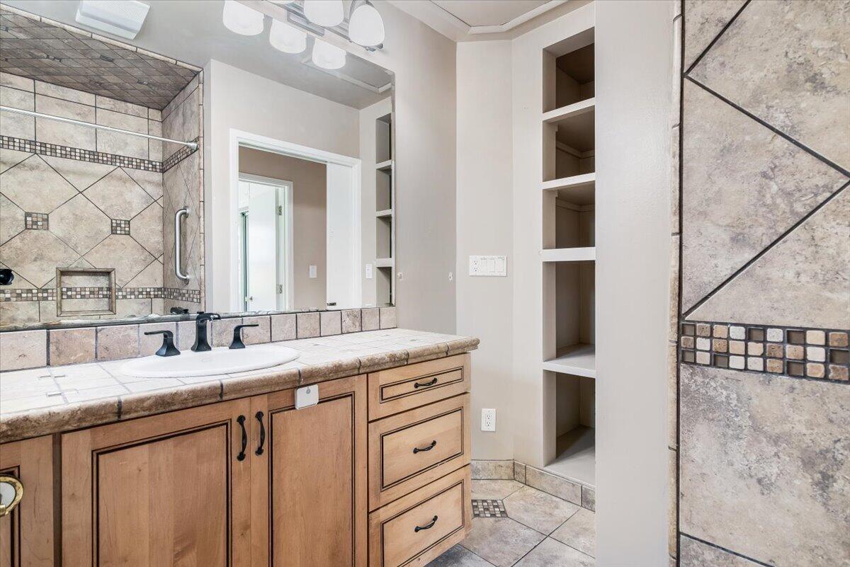 230 North D Street Lompoc, CA 93436 - Photo 19 of 29 a bathroom with a granite countertop sink and a mirror