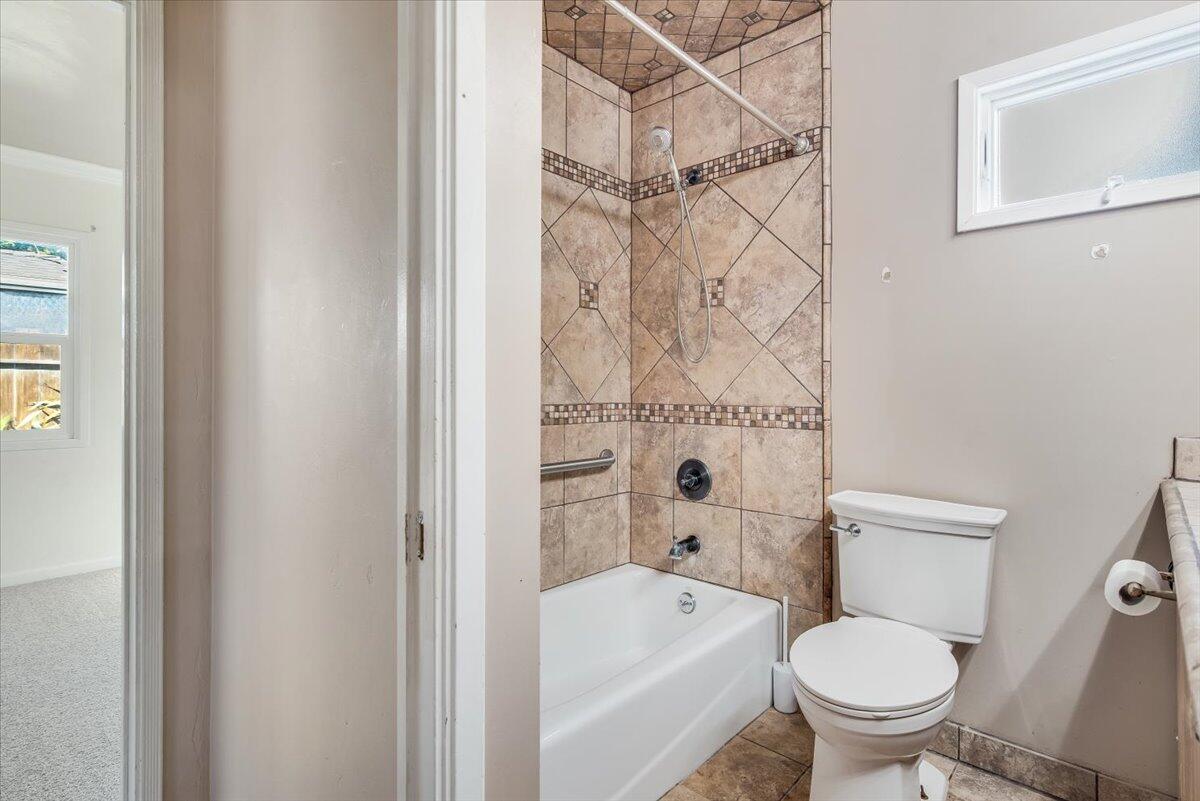 230 North D Street Lompoc, CA 93436 - Photo 20 of 29 a white toilet sitting next to a bath tub