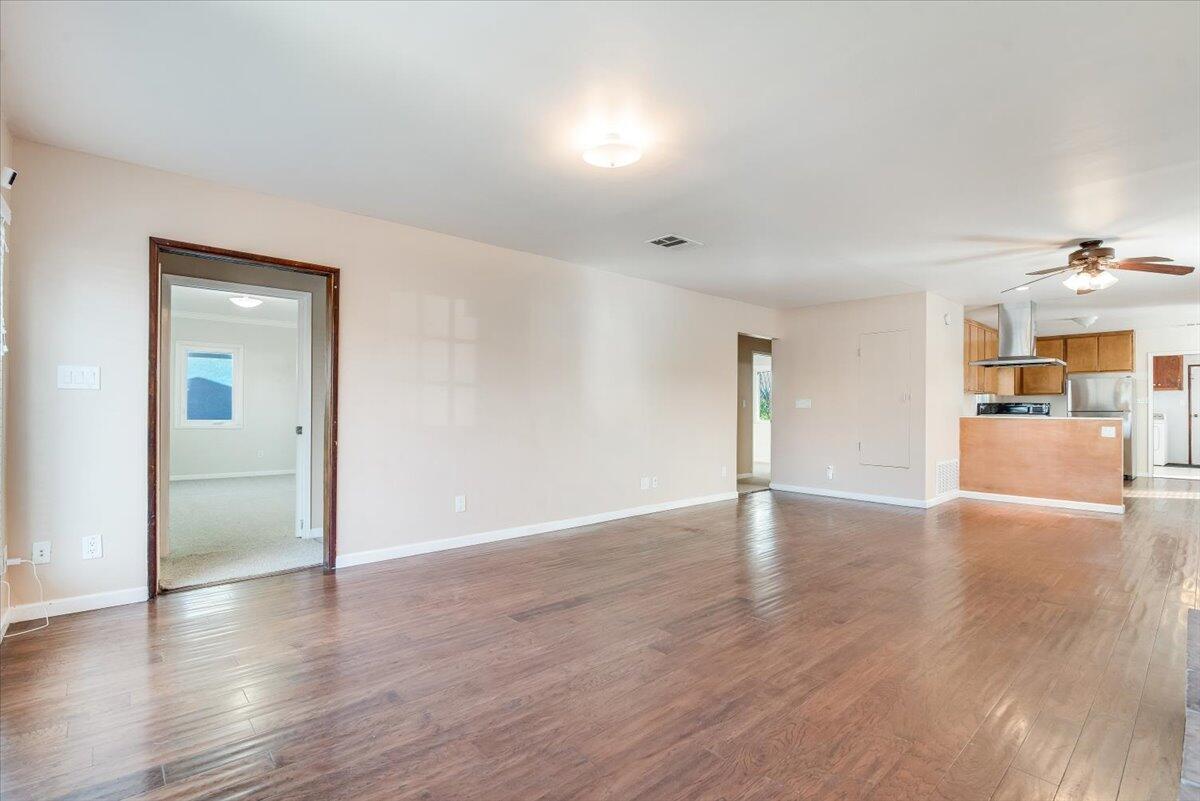 230 North D Street Lompoc, CA 93436 - Photo 3 of 29 a view of a livingroom with wooden floor and kitchen space with a sink
