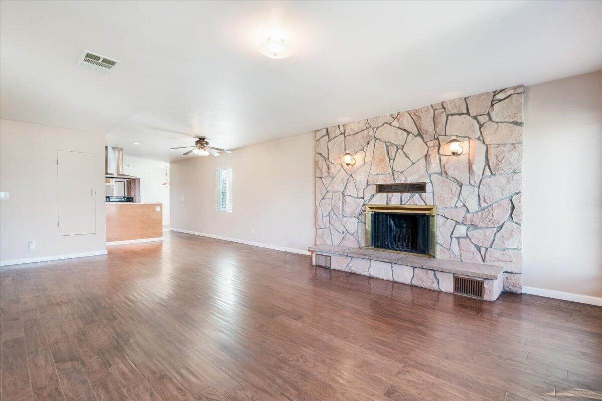 230 North D Street Lompoc, CA 93436 - Photo 4 of 29 a view of empty room with wooden floor and fireplace
