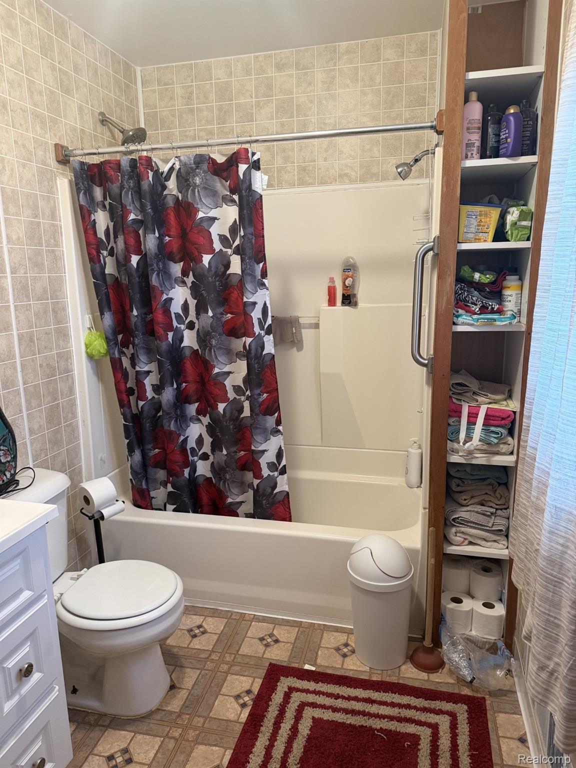5200 Mayville Road Clifford, MI 48727 - Photo 12 of 17 Bathroom with shower / bath combo with shower curtain, light flooring, tile walls, and vanity