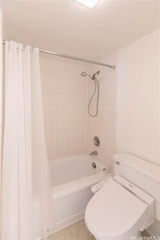 a bathroom with a toilet and a bathtub