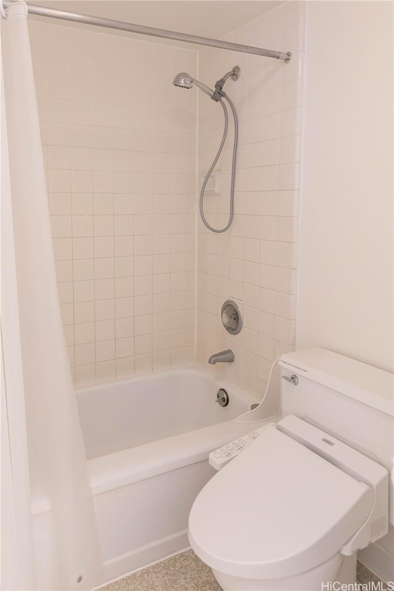 2240 Kūhiō Avenue, Unit 2608 Honolulu, HI 96815 - Photo 13 of 25 a bathroom with a sink a toilet and a bathtub