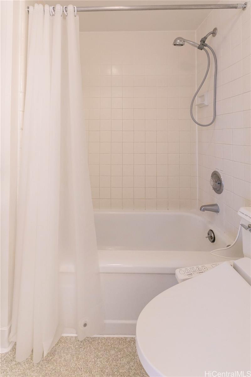 2240 Kūhiō Avenue, Unit 2608 Honolulu, HI 96815 - Photo 14 of 25 a bathroom with a shower and a bathtub