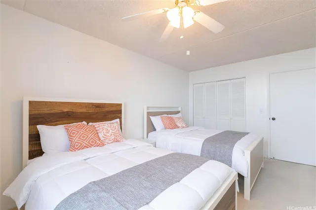 a bedroom with two beds and a chandelier