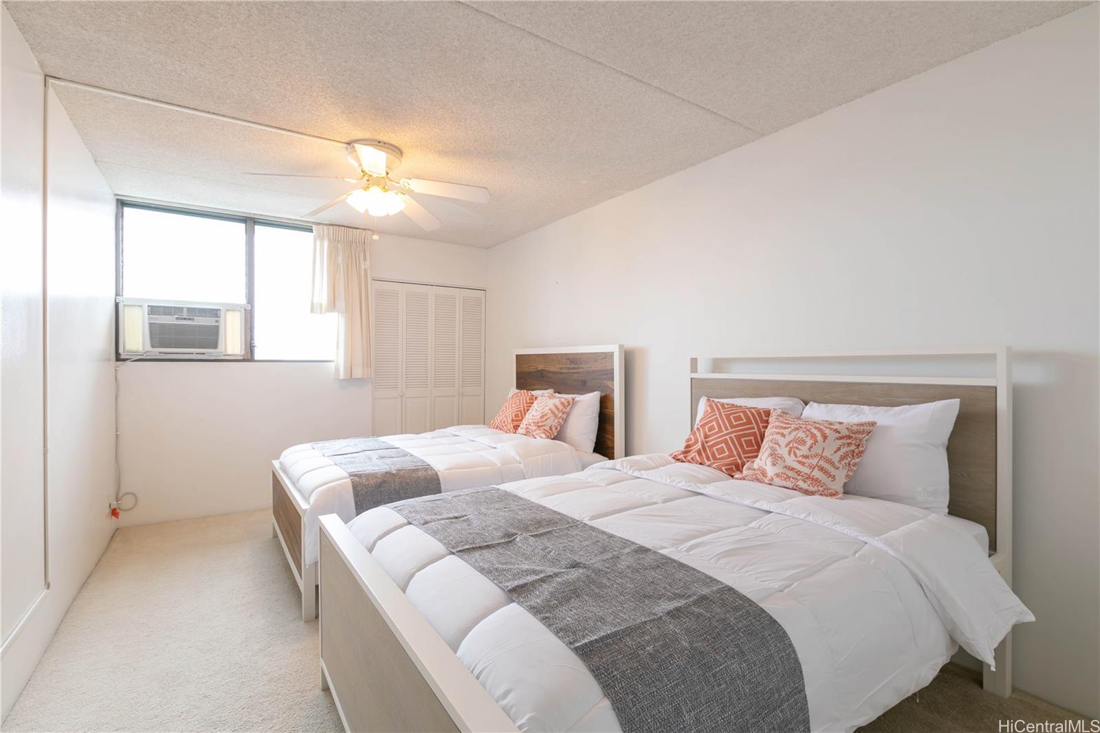 2240 Kūhiō Avenue, Unit 2608 Honolulu, HI 96815 - Photo 2 of 25 a bedroom with a bed and a chandelier
