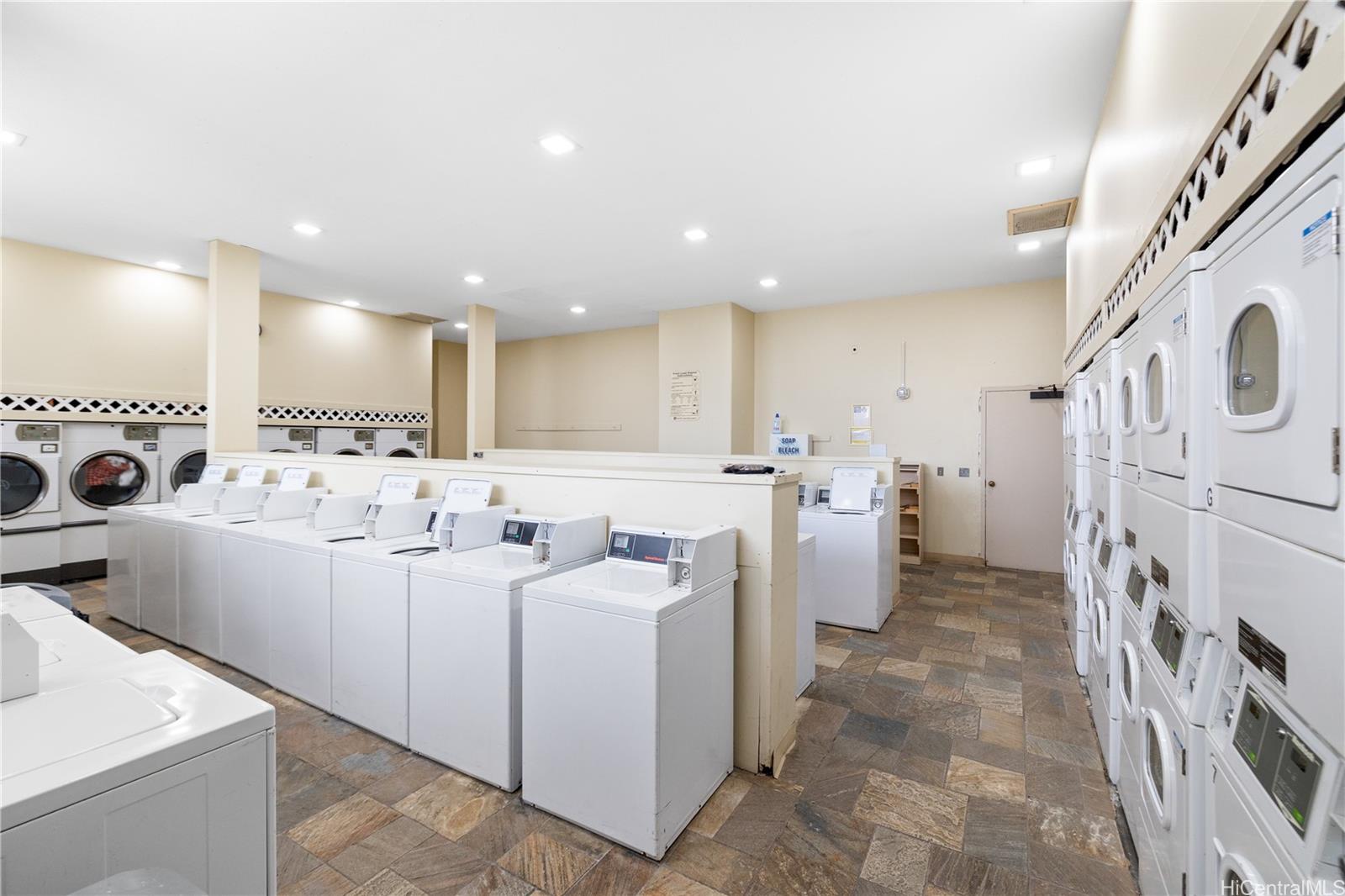 2240 Kūhiō Avenue, Unit 2608 Honolulu, HI 96815 - Photo 24 of 25 a view of a kitchen with refrigerator and washer