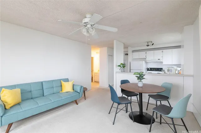 a living room with furniture and kitchen view
