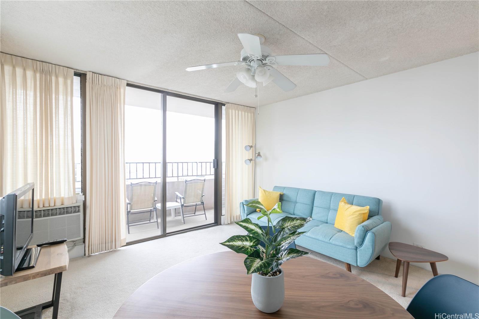 2240 Kūhiō Avenue, Unit 2608 Honolulu, HI 96815 - Photo 5 of 25 a living room with furniture and a potted plant