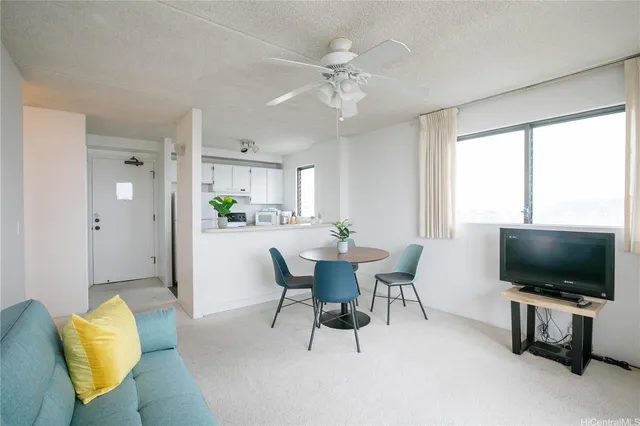 a view of a livingroom with furniture and a flat screen tv