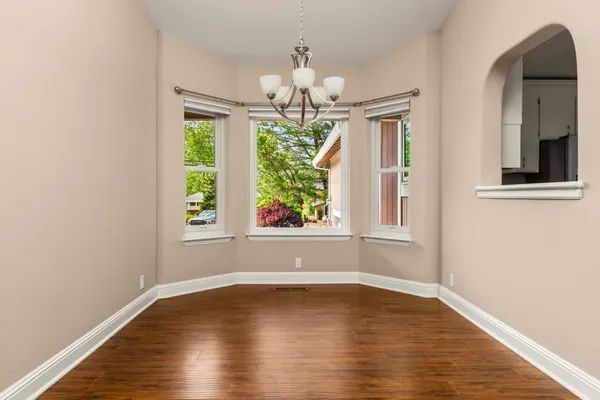 a view of wooden floor and windows in a room