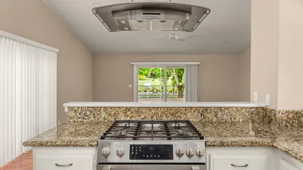 a spacious bathroom with a granite countertop sink a toilet and a window
