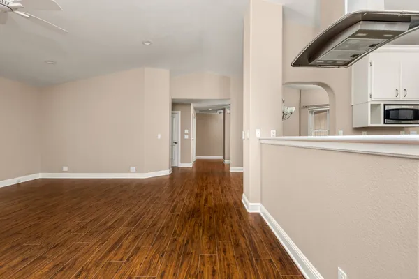 a spacious bathroom with a granite countertop sink a toilet a mirror and shower