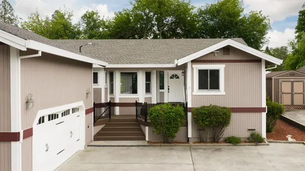 a front view of a house with a yard