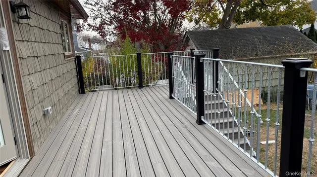 a view of balcony with wooden floor and fence