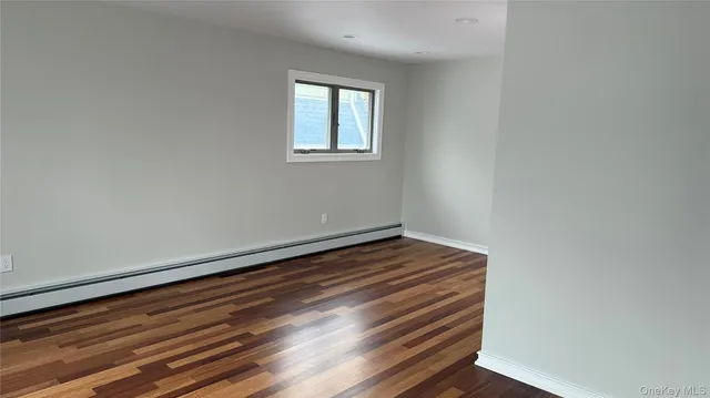 a view of room with wooden floor and window