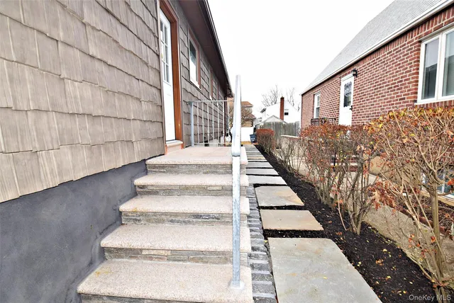a view of backyard with wooden fence and large trees