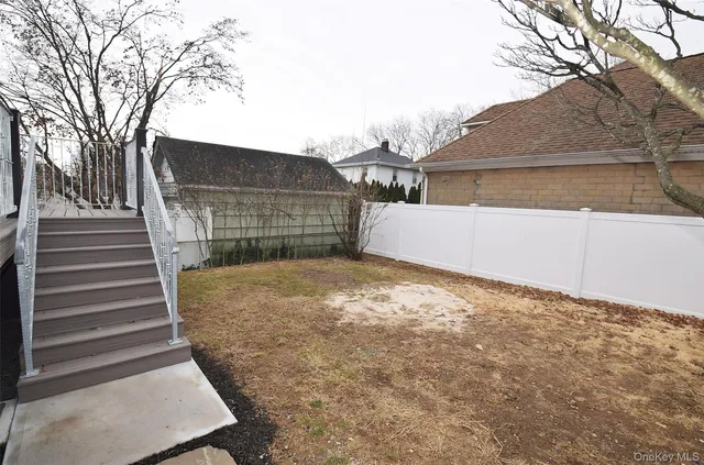 a view of a house with a yard and sitting area
