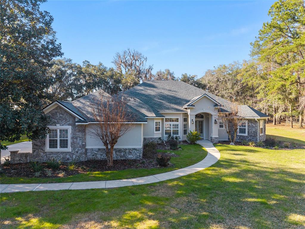 10614 Southwest 15th Lane Gainesville, FL 32607 - Photo 2 of 85 a front view of a house with a garden and trees