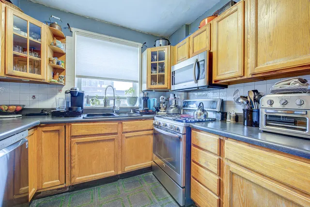 a kitchen with stainless steel appliances granite countertop a sink and cabinets