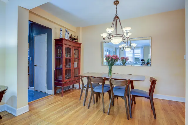 a view of a dining room with furniture wooden floor and chandelier