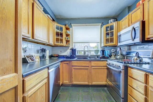 a kitchen with stainless steel appliances granite countertop a sink and cabinets