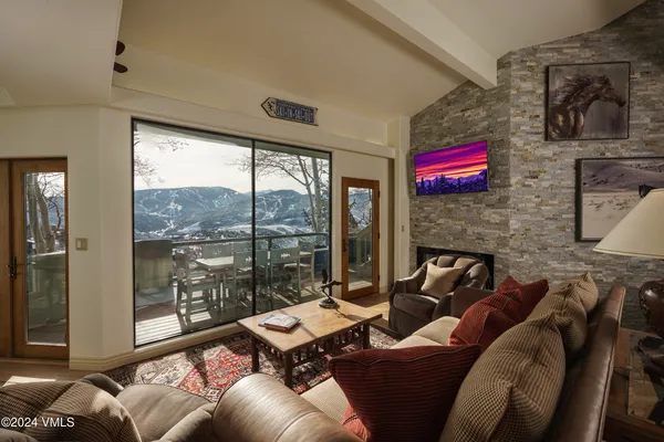 a living room with furniture and a floor to ceiling window