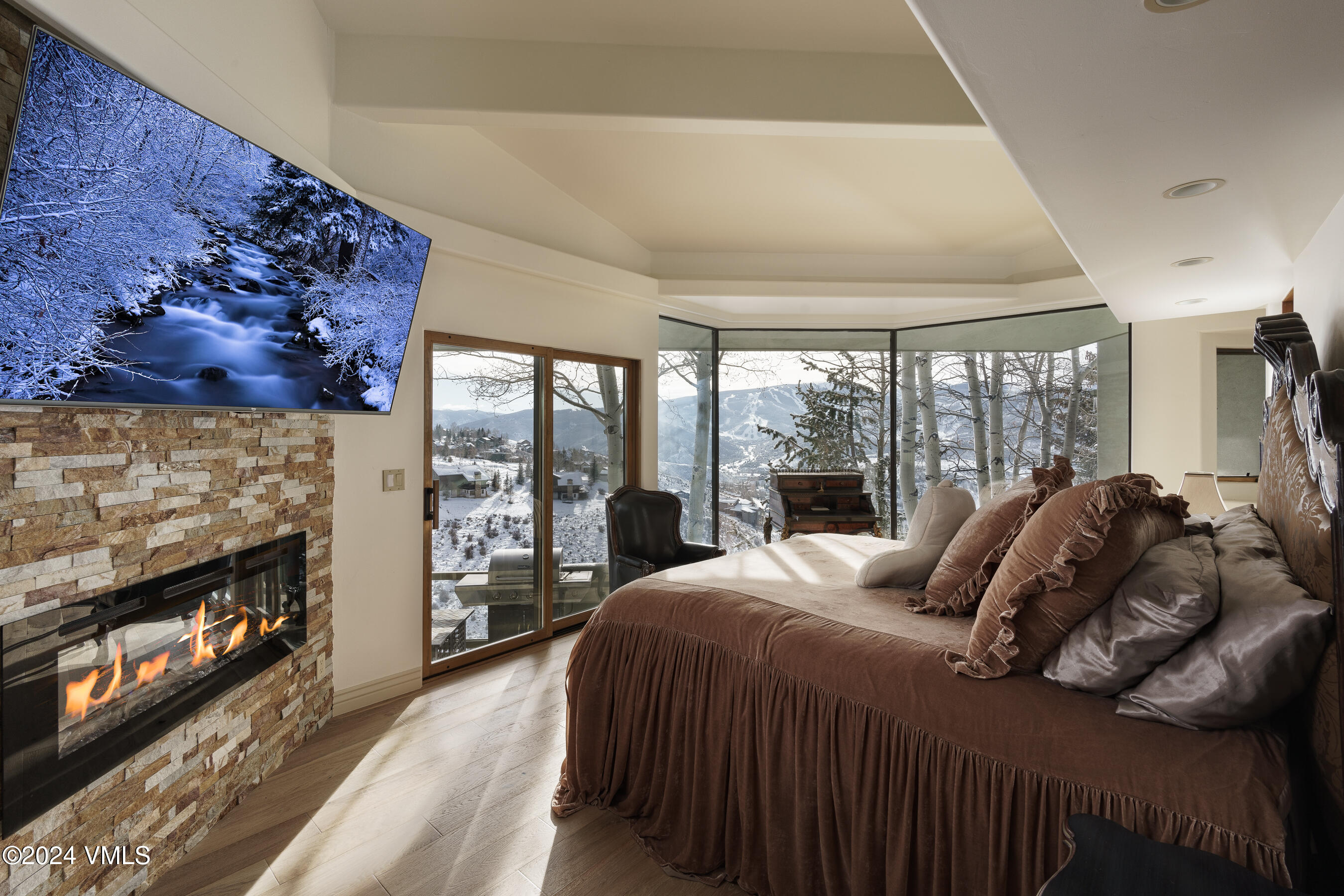 4747 Wildridge Road Avon, CO 81620 - Photo 2 of 51 a bedroom with a bed a fireplace and a large window