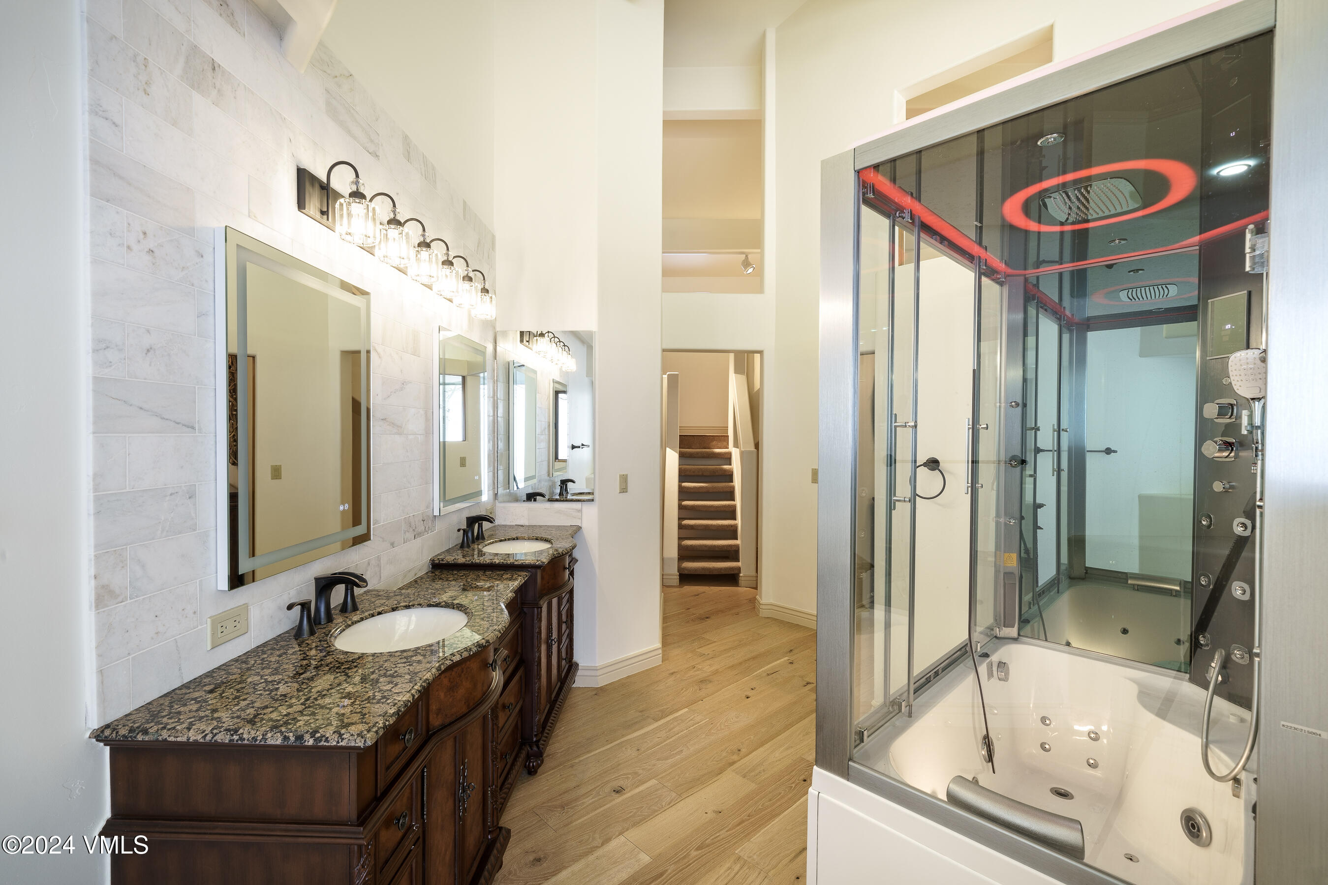 4747 Wildridge Road Avon, CO 81620 - Photo 28 of 51 a bathroom with a granite countertop tub sink and mirror