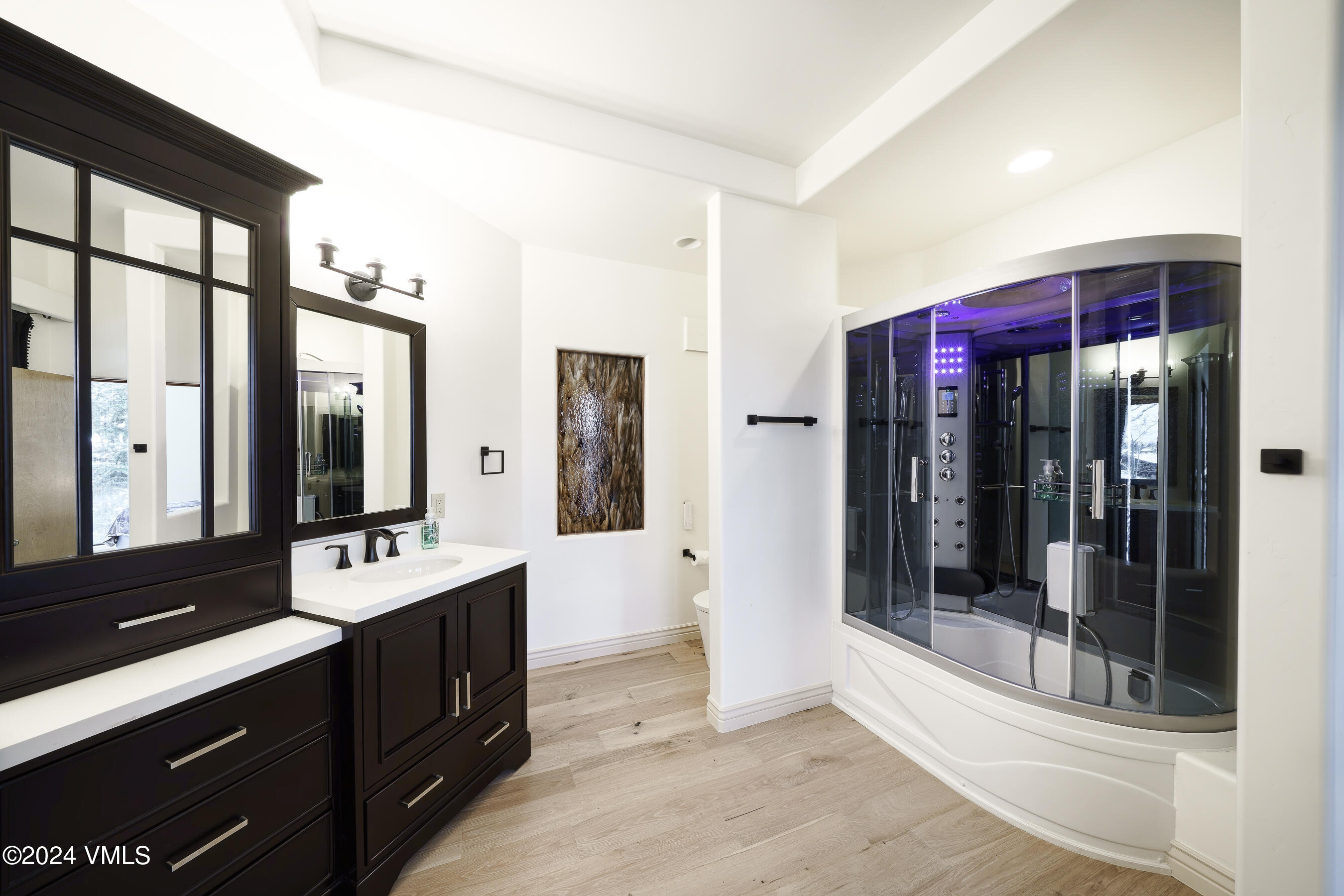 4747 Wildridge Road Avon, CO 81620 - Photo 36 of 51 a spacious bathroom with a shower sink and mirror