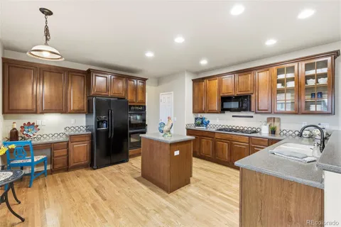 a kitchen with stainless steel appliances granite countertop a refrigerator stove and sink