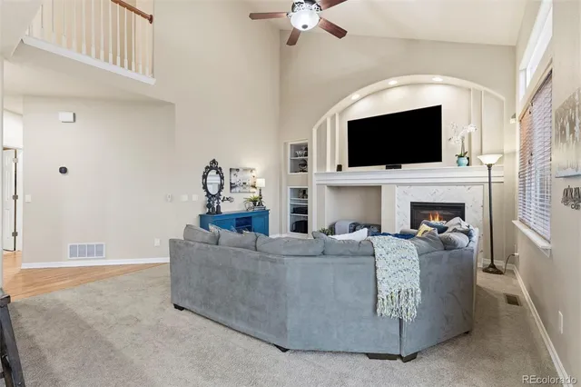 a living room with fireplace furniture and a flat screen tv