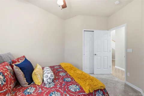 a bedroom with a bed and a painting on the wall