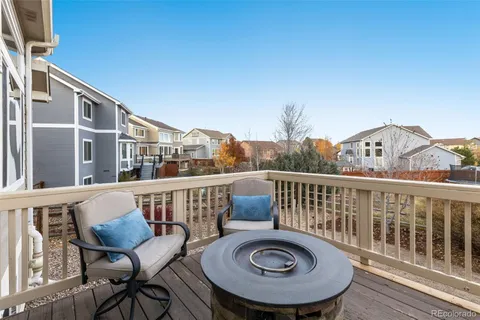 a view of a chair and tables in the balcony
