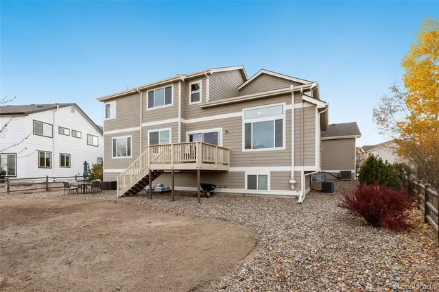 a view of a big house with a yard and balcony