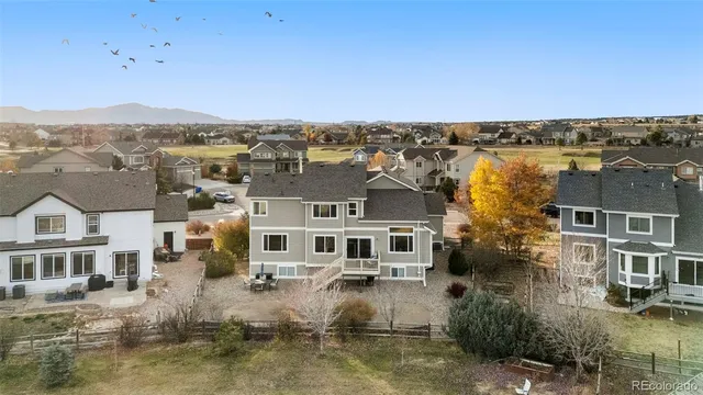 an aerial view of residential houses with outdoor space and river