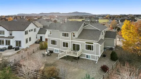 an aerial view of residential houses with outdoor space and trees