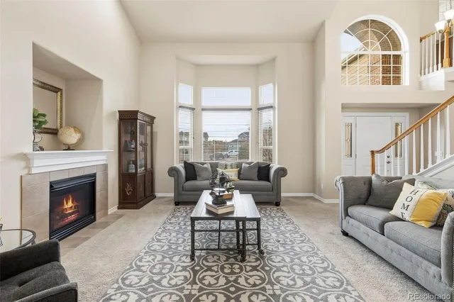 a living room with furniture fireplace and window