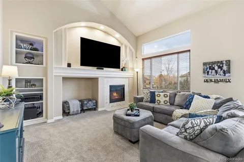a living room with furniture fireplace and flat screen tv