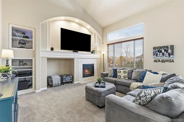 a living room with furniture fireplace and flat screen tv