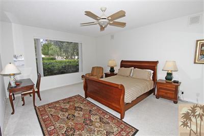 815 Inverness Drive Rancho Mirage, CA 92270 - Photo 13 of 25 a bedroom with a bed and a table in it
