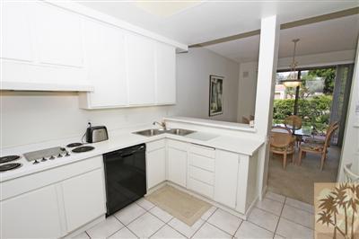 815 Inverness Drive Rancho Mirage, CA 92270 - Photo 8 of 25 a kitchen with a sink stove and cabinets