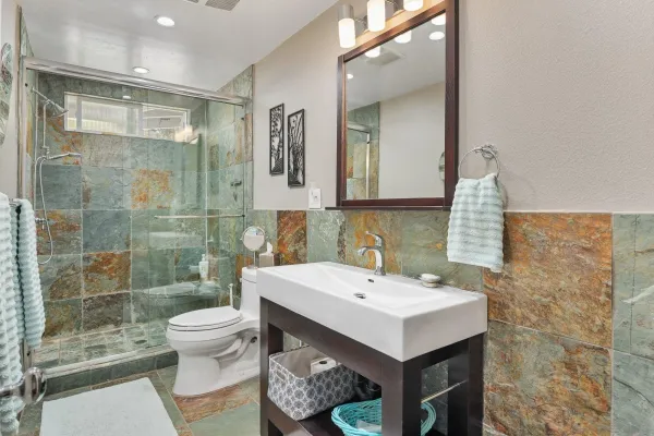 a bathroom with a sink toilet and shower